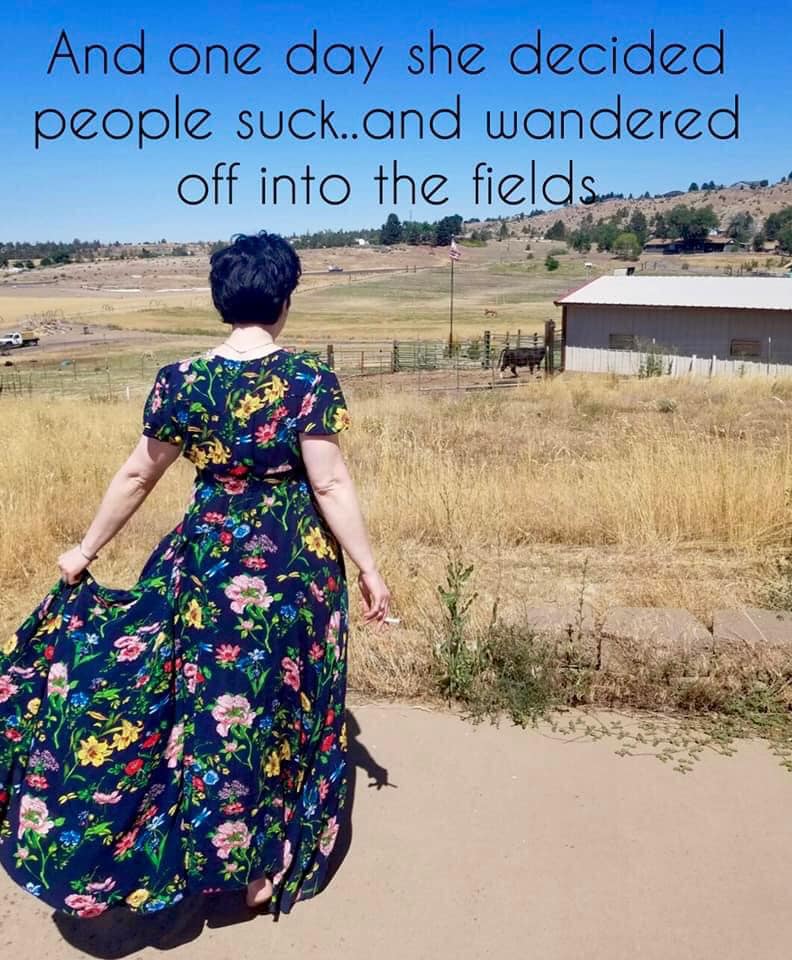 This meme features a woman walking away from a rural setting, with a humorous quote about her decision to leave her life behind. The text reads: "And one day she decided people suck...and wandered off into the fields." The image is meant to be humorous and relatable, poking fun at the idea of wanting to escape from the stresses of life.